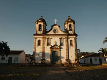 Cinematic wide-angle equirectangular screenshot of a historic colonial church in Minas Gerais, dramatic golden hour natural light, rich contrast
