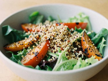 Editorial photograph of a vibrant, colorful salad bowl with mixed greens, roasted vegetables, and quinoa, soft natural daylight, shallow depth of field.