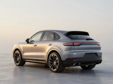 Rear three-quarters view of a metallic silver Porsche Cayenne Coupe, clean minimalist background, elegant studio lighting, high-end automotive finish.