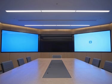 Wide-angle shot of a modern corporate boardroom with integrated AV, crisp display screens, and architectural lighting, cool blue tones.