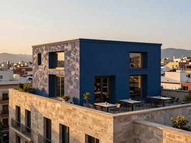 Modernist terrace overlooking Barcelona urban grid, clean architectural lines, upscale outdoor seating, golden hour