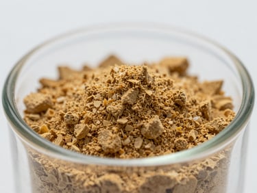Macro close-up of fine lyophilized powder in a shallow glass vial, warm golden crystalline texture, cool even studio lighting on white background, clinical precision framing