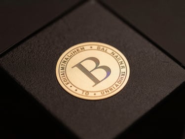 Macro close-up of a holographic authenticity seal on a luxury perfume box, dark obsidian background, sharp gold highlights, low-key lighting.