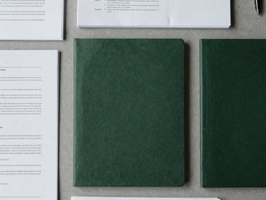 Flat-lay overhead shot of organized physical documents on a slate gray desk, cool overcast daylight, soft natural shadows, sharp focus, 35mm