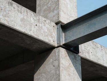 Strict eye-level architectural details showing concrete and steel joints, sharp directional light with deep shadows, cool daylight.