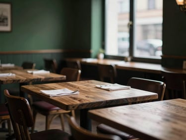 Moody Scandinavian restaurant interior, empty sunlit tables near a window, soft shadows, rustic wooden textures, shallow depth of field, 35mm.