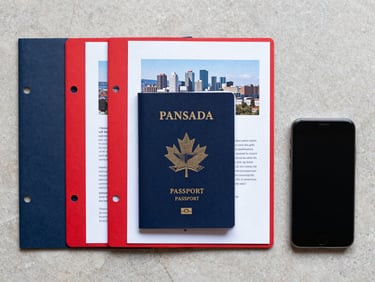 Precise top-down flat-lay of a Canadian passport, structured document folders, and a smartphone on a clean stone desk, natural daylight, no hands