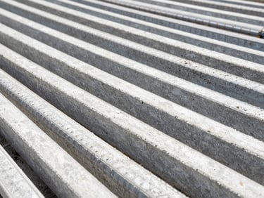 Close-up of concrete reinforcement steel bars on a construction site, geometric patterns, bright daylight