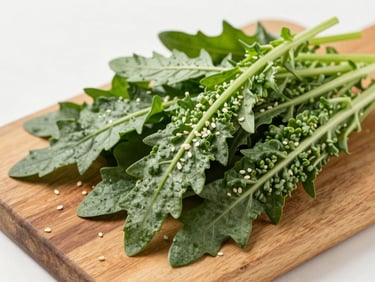 Overhead shot of fresh bitter greens and wild sesame leaves on a wooden board, bright overcast natural daylight, clean editorial food photography, 35mm
