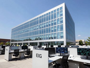 Clean, structured interior shot of the EIG Wireless office headquarters in Charlotte, NC. Modern workstations, large monitors displaying network diagrams, subtle branding. Bright, high-contrast daylight.
