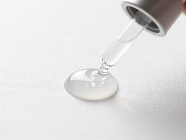 Macro shot of clinical skincare serum droplets on a pristine white surface, sterile clinical lighting.