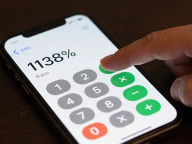 Macro shot of a finger tapping a loan calculator app on a smartphone screen, dark desk background, screen displaying interest rate percentage in sharp focus