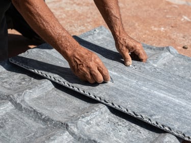 Close-up of hands shaping slate grey zinc roofing material, high contrast shadows, industrial realism, 35mm