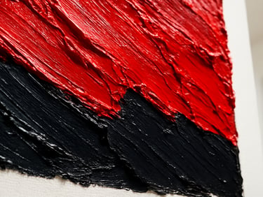 An extreme close-up detail of thick, textured oil paint strokes of vibrant crimson and deep black, catching bright natural gallery light, 35mm