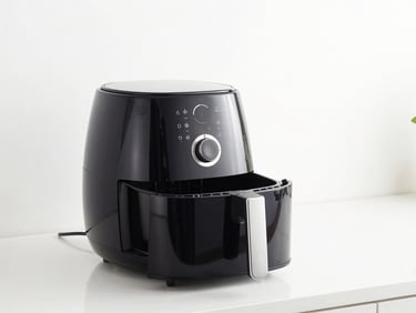 Sleek modern air fryer on a clean kitchen counter, bright studio lighting, white background