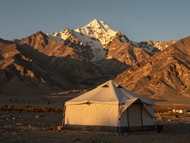 A solitary luxury tent pitched in the high-altitude desert of Ladakh, surrounded by stark Himalayan peaks at sunset, warm golden glow, 35mm lens