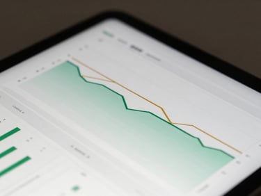 Macro tight shot of a clean, modern digital investment dashboard on a tablet screen, soft diffused architectural light, focused on green and gold charts, minimalist aesthetic.