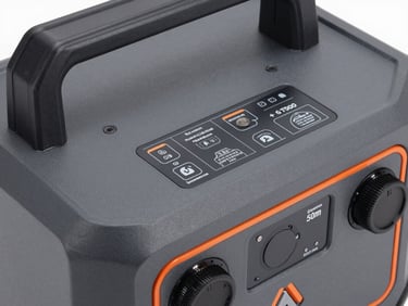 Close-up of a rugged portable power station enclosure, matte slate finish, technical spec labels visible, sharp studio lighting, 50mm lens