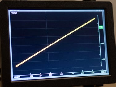 Macro detail of a high-tech telemetry terminal displaying orbital trajectory calculations, cool-toned blue backlighting, sharp technical lines