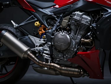 Detailed close-up of a high-performance motorcycle engine and exhaust pipe, dark moody lighting, metallic reflections