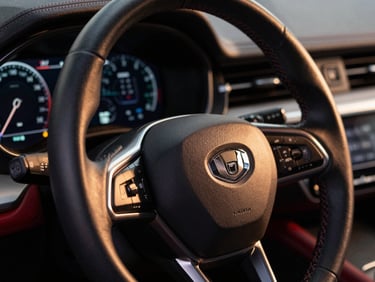 Macro shot of a modern leather steering wheel and digital dashboard, warm ambient light, high-contrast details