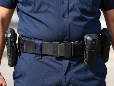 Dynamic close-up of a tactical belt and official Canarian police uniform details, sharp focus, bright daylight