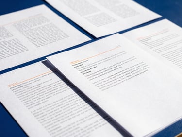 Structured legal documents with handwritten annotations, clean desk setup, deep blue shadows, high contrast