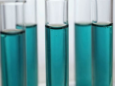 Macro close-up of sterile glass photobioreactor tubes filled with bubbling deep teal microalgae cultures, clinical white background.