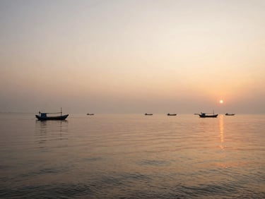 Serene coastal view of Chilika Lake at sunrise, soft morning mist, traditional fishing boats in the distance, calm waters. Panoramic.