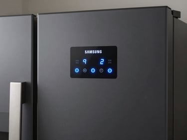 Close-up of a modern Samsung digital inverter refrigerator control panel with glowing blue LED temperature indicators.