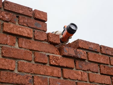 Close-up of a mason meticulously performing tuckpointing on historic red brick, natural overcast daylight, warm terracotta tones, sharp focus, 35mm lens