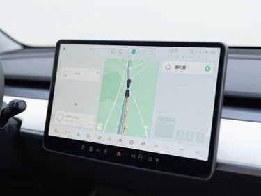 Close up of a modern car dashboard screen showing GPS navigation, bright daylight, clean interior, sharp focus