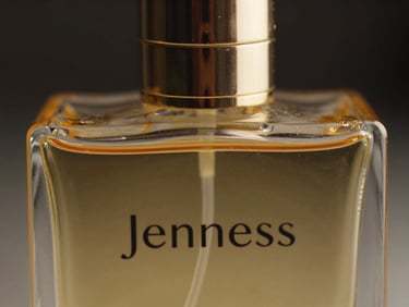 Extreme close-up macro shot of the Jenness perfume bottle, gold reflections on heavy glass, dark background with subtle amber rim light