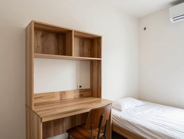 Bright architectural photography of a cozy studio apartment interior in India, natural daylight, compact study desk, single bed, realistic color palette, crisp focus.