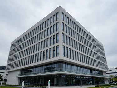 Crisp, overcast daylight architectural shot of a modern corporate headquarters with subtle security monitoring indicators, clean lines, wide perspective.