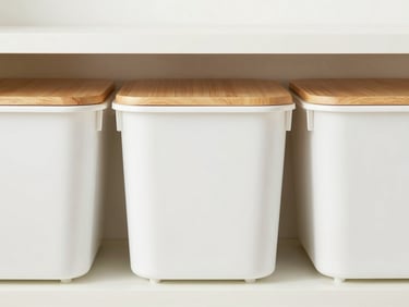Straight-on view of modular white storage bins with warm oak lids on a shelf, clean minimalist setting