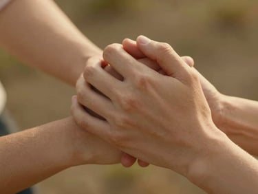 Intimate close-up of a couple's hands intertwined, warm golden light, soft focus background
