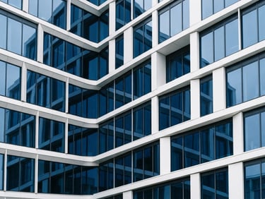 Abstract architectural details of a modern office building facade, bright overcast daylight, clean white and deep blue tones, sharp focus, 35mm
