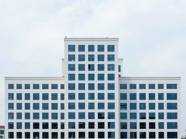 Abstract high-altitude urban planning, geometric compositions, bright overcast daylight, clean white and deep blue tones, sharp focus, 35mm