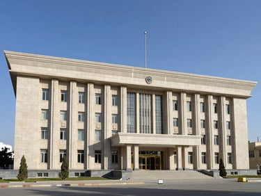 A clean, architectural shot of a modern civic building in Kabul under clear blue daylight, representing institutional transparency and order