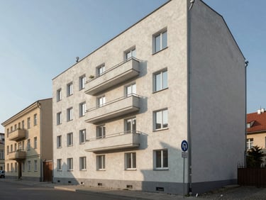Vilnius residential building exterior on a quiet street, wide environmental framing, morning daylight, no people, clean architectural lines
