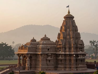 Wide environmental shot of Akshardham temple in Delhi at sunrise, soft morning mist, golden light reflecting on stone carvings