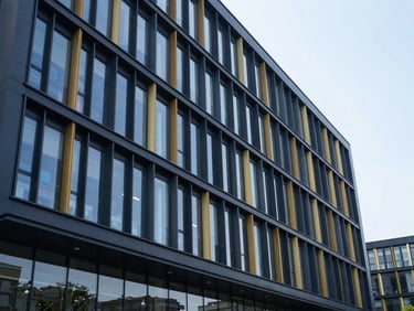 Clean architectural shot of a modern university research building facade, cool daylight, precise geometry, deep navy reflections, 35mm