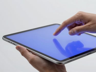 Sleek editorial photography of hands interacting with a clean, minimalist tablet interface, electronic blue light reflecting, sharp focus.