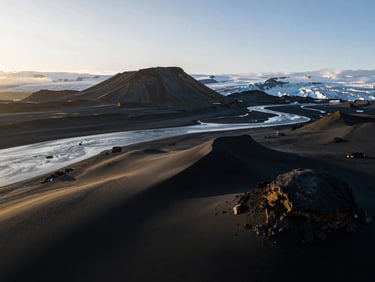 Cinematic drone shot of volcanic black sand beaches and glacial rivers in Iceland, high contrast, golden hour lighting, 35mm lens.