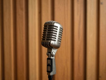 A warm-toned studio setup with a vintage microphone, acoustic wood paneling, soft golden-hour lighting, shallow depth of field