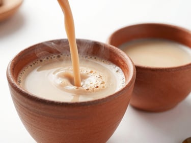 Close-up macro shot of steaming hot chai being poured into a traditional clay cup, bright natural light.