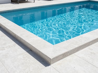 Architectural close-up of a modern residential pool showing clean concrete lines and pristine water, midday sun
