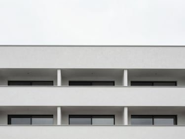 Minimalist modern apartment facade in Porto, clean lines, soft overcast daylight, desaturated tones