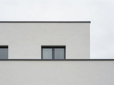 Minimalist architectural detail of a Scandinavian-inspired residential facade with clean geometric lines, soft overcast daylight, desaturated tones